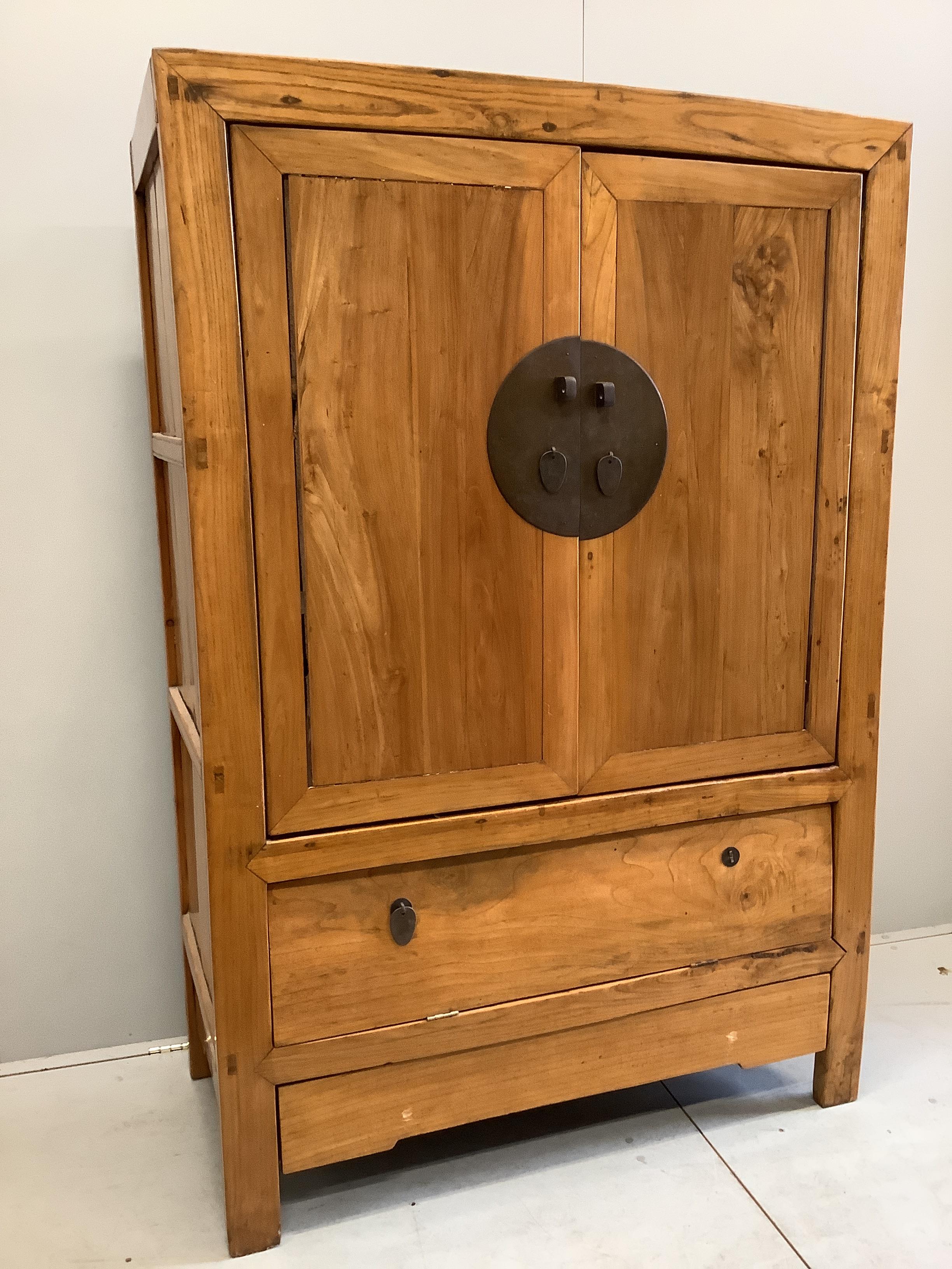 A Chinese elm cabinet, width 115cm, depth 55cm, height 169cm